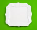 White figured plate on green top view