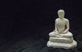 White figurine of siddhartha gautama buddha sculpture statue with dark background Royalty Free Stock Photo