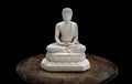 White figurine of siddhartha gautama buddha sculpture statue with dark background Royalty Free Stock Photo