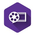 White Film reel and play video movie film icon isolated with long shadow. Purple hexagon button Royalty Free Stock Photo