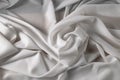 White fine chiffon fabric with a woven texture. Gathered in a spiral and crushed textiles. Silky light