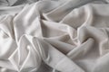 White fine chiffon fabric with a woven texture. Gathered in a spiral and crushed textiles. Silky light