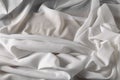 White fine chiffon fabric with a woven texture. Gathered in a spiral and crushed textiles. Silky light