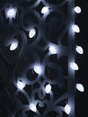 White fir cones Christmas lights garland on dark background. Christmas or new year led lights garland a lot. Blurred glowing light Royalty Free Stock Photo