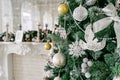 White fireplace decorated with candles and fir branches. Decorated Christmas tree. Classic apartments, morning in hotel Royalty Free Stock Photo