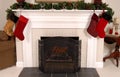 White fireplace decorated for Christmas