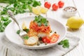 White fish cod, Pollock, nototenia, hake, braised with onions, carrots and tomatoes