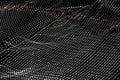 White fish net with red line and black background, close up of white crisscross lines