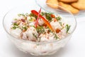 White fish Peruvian ceviche served in a transparent bowl with crackers