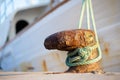 A fishing trawler in the harbor is tied to a rusted bollard with a rope. Royalty Free Stock Photo