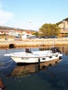 White fisherman boat with reflection on pierce in the sea in the evening in Rab Croatia