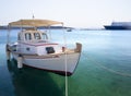 White fishing boat with an awning in the port of the Greek resort town of Marmari on the island of Evia in Greece Royalty Free Stock Photo