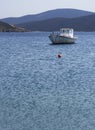 White fishing boat with an awning in the port of the Greek resort town of Marmari on the island of Evia in Greece Royalty Free Stock Photo