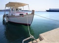 White fishing boat with an awning in the port of the Greek resort town of Marmari on the island of Evia in Greece Royalty Free Stock Photo