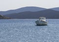 White fishing boat with an awning in the port of the Greek resort town of Marmari on the island of Evia in Greece Royalty Free Stock Photo