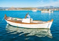 White fishing boat with greek flag in Naflpio harbor in Greece Royalty Free Stock Photo