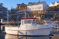 White fishing boat on the harbor waterfront