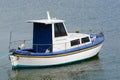 White fishing motor boat anchored in the sea