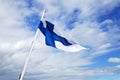 White Flag With Blue Cross On Blue Sky Background