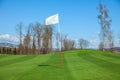 White flag in the center of a golf course in Otocec, Slovenia Royalty Free Stock Photo