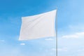 White flag with clean texture against a vibrant blue sky, perfect for flag mockups Royalty Free Stock Photo