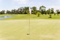 White flag at the golf course of on green with blue sky Royalty Free Stock Photo