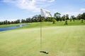 White flag at the golf course of on green with blue sky Royalty Free Stock Photo