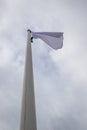 White flag on the mast near the beach. Flag on a background of cloudy sky Royalty Free Stock Photo