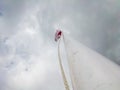 a white flagpole with a red and white flag flying Royalty Free Stock Photo