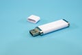 White flash drive isolated on a blue background. Close-up.