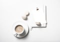 White flat lay with beige macaroons, coffee cup, notepad and pos