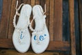 White flat wedding shoes for bride with I DO