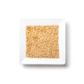 White flax seeds on a plate on white