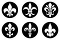 White Fleur-de-lis symbols in a black circle frame. Royalty Free Stock Photo