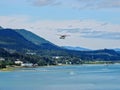 White Float Pontoon Seaplane Taking off from Juneau Harbor