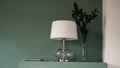 White floor lamp and vase on green background modern minimalistic interior Royalty Free Stock Photo