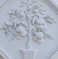 A white floral plaster relief on a white plastered wall Royalty Free Stock Photo