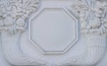 A white floral plaster relief on a white plastered wall Royalty Free Stock Photo