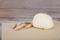 A white flour bun and a few ripe wheat ears Royalty Free Stock Photo