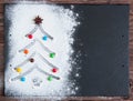 White flour Christmas tree frame on black background, close up, copy space