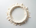 White flour circle on clean white background. Powder is scattered around edge of circle. Flour texture is visible. Background is Royalty Free Stock Photo