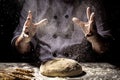 White flour flying into air as pastry chef in white suit slams ball dough on white powder covered table. concept of nature, Italy Royalty Free Stock Photo