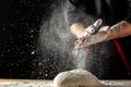 White flour flying into air as pastry chef in white suit slams ball dough on white powder covered table. concept of nature, Italy Royalty Free Stock Photo