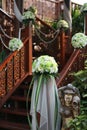 White flowers bouquet decorative on railing stair and garden of Thai wooden house for wedding ceremony