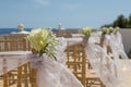 White flowers on chairs before a wedding ceremony