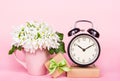 White flowers, gift box and alarm clock. Bouquet Galanthus. Mothers Day. Royalty Free Stock Photo