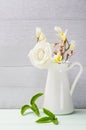 White flowers in jug. Roses in jug. Royalty Free Stock Photo