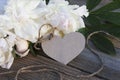 White flowers of peonies and a card card in the form of a heart on a wooden background. Mock up, greeting card. postcard Royalty Free Stock Photo