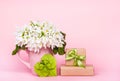 White flowers on pink background. Flowers, origami heart and gift box. Royalty Free Stock Photo