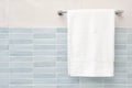 White fluffy bath towel hanging on wall rail in bathroom Royalty Free Stock Photo